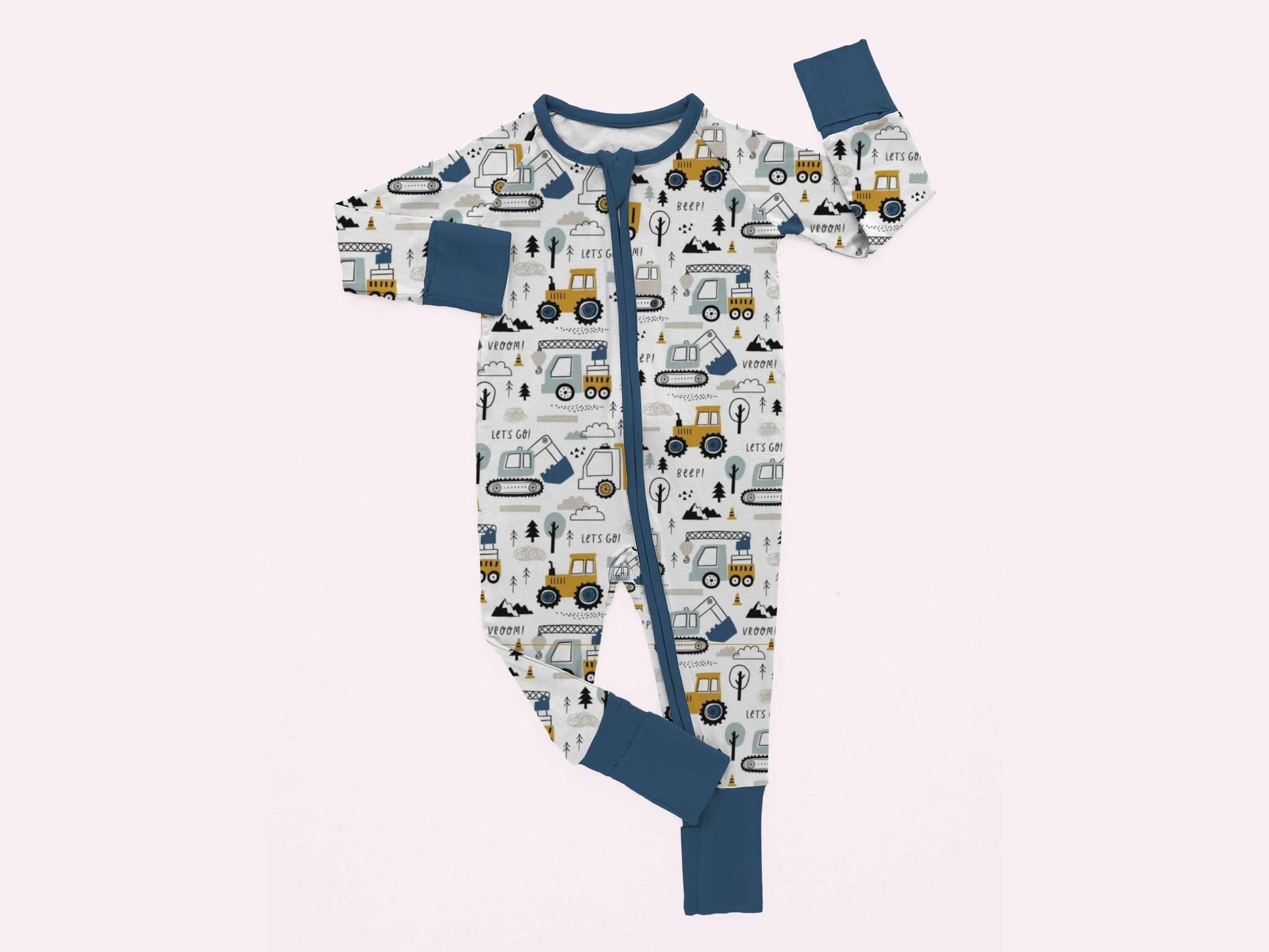 a pair of amboo zippy pajamas featuring our construction zone print laying on a white background