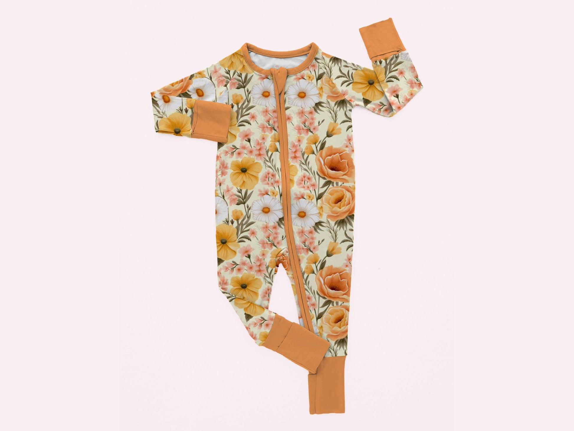 A baby's long-sleeved footie pajama with a floral print design in shades of orange, yellow, and green.