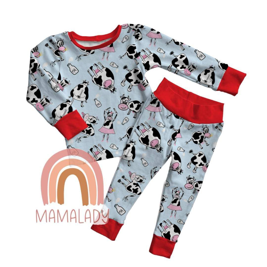 our ballerina cow print bamboo two piece pajama set laying on a white background with our mamalady logo in the corner