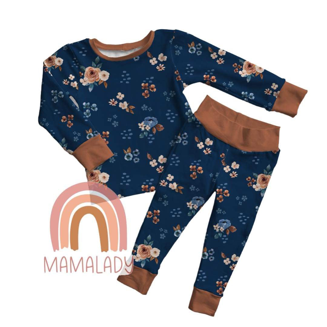 our midnight blossom print bamboo two piece pajama set laying on a white background with our mamalady logo in the corner