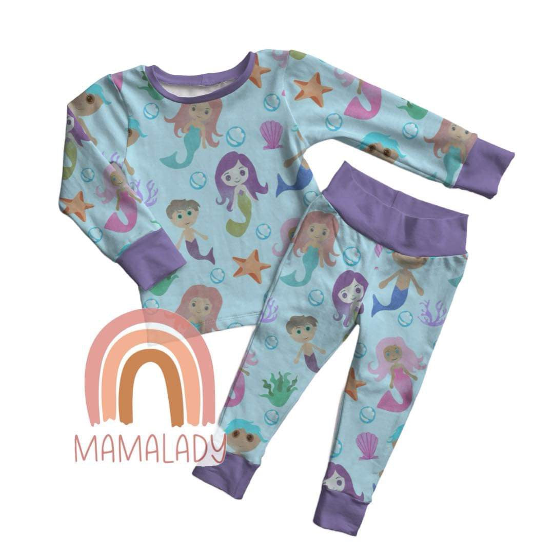 our watercolor mermaid print bamboo two piece pajama set laying on a white background with our mamalady logo in the corner