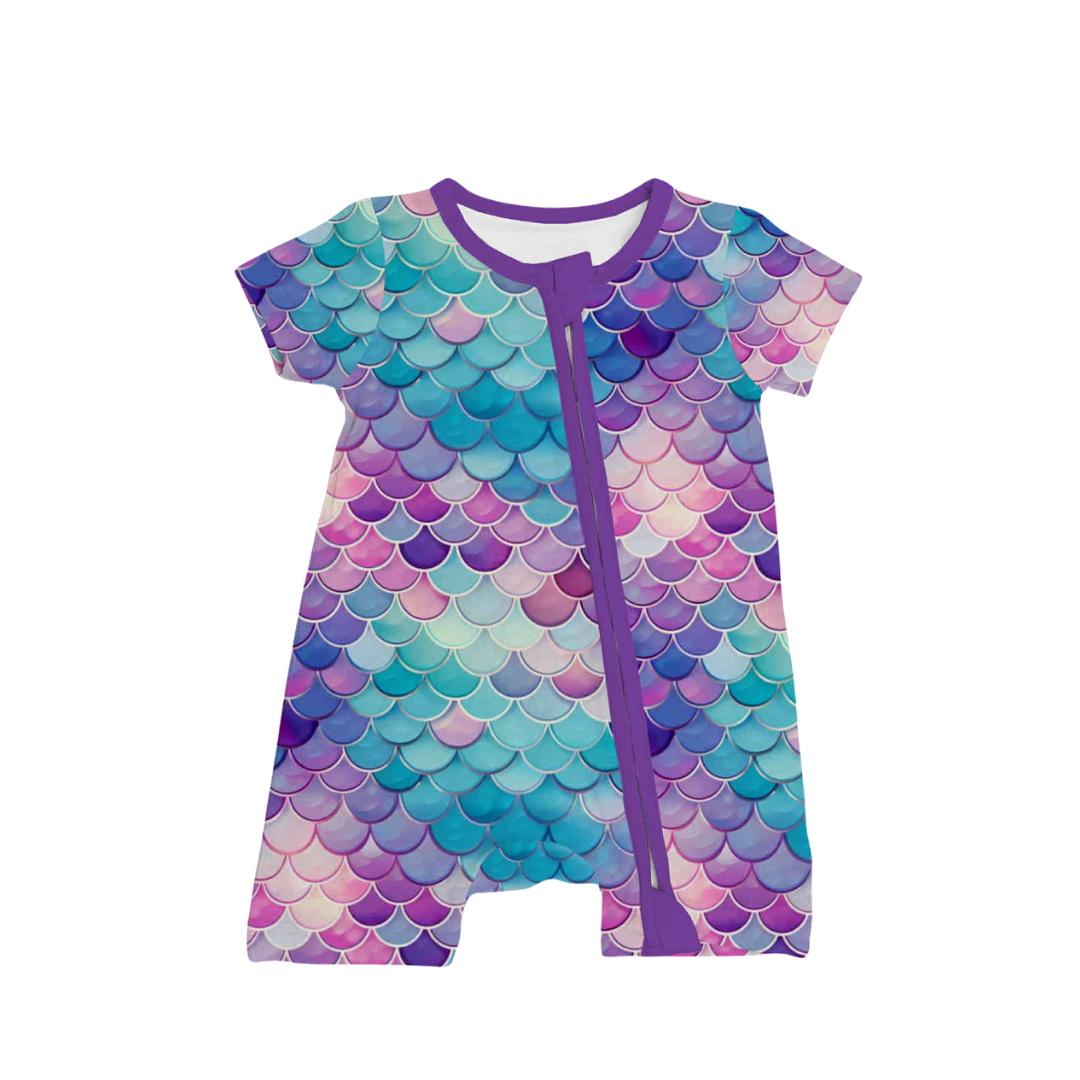Children's bamboo zippy pajama with purple mermaid scale print, displayed on a white background. Features a two-way zipper and soft bamboo fabric.