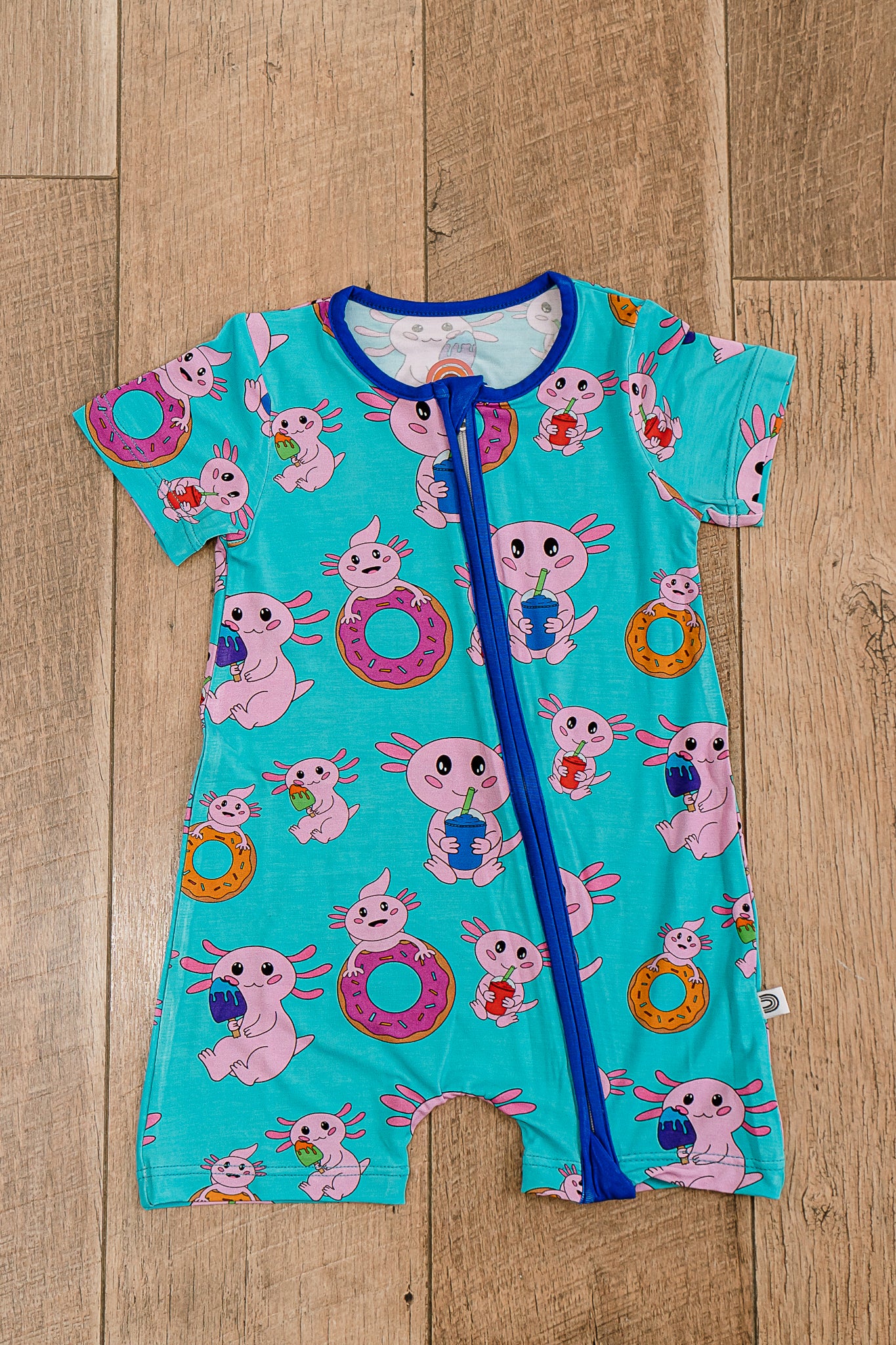 Axolotlicious bamboo short sleeve zippy laid flat, showcasing colorful axolotl design with short sleeves and two-way zipper