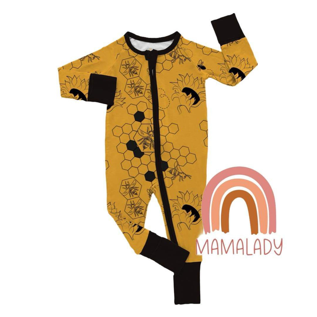 our busy bee print bamboo zippy with fold over cuffs laying on a white background with our mamalady logo in the corner