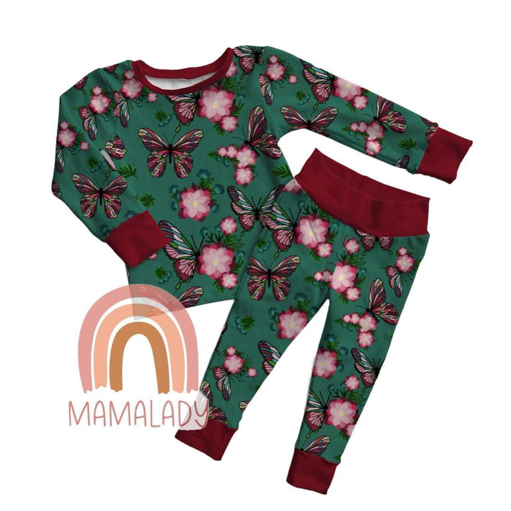 a pair of our emerald butterfly print two piece pajama set laying on a white background with our mamalady logo in the corner