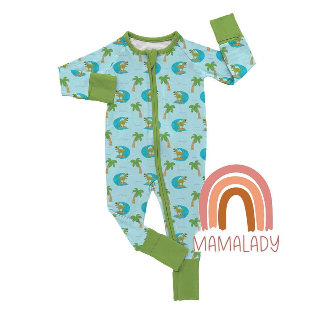 our surfing dinosaur print pajamas in bamboo laying on a white background with our mamalady logo in the corner