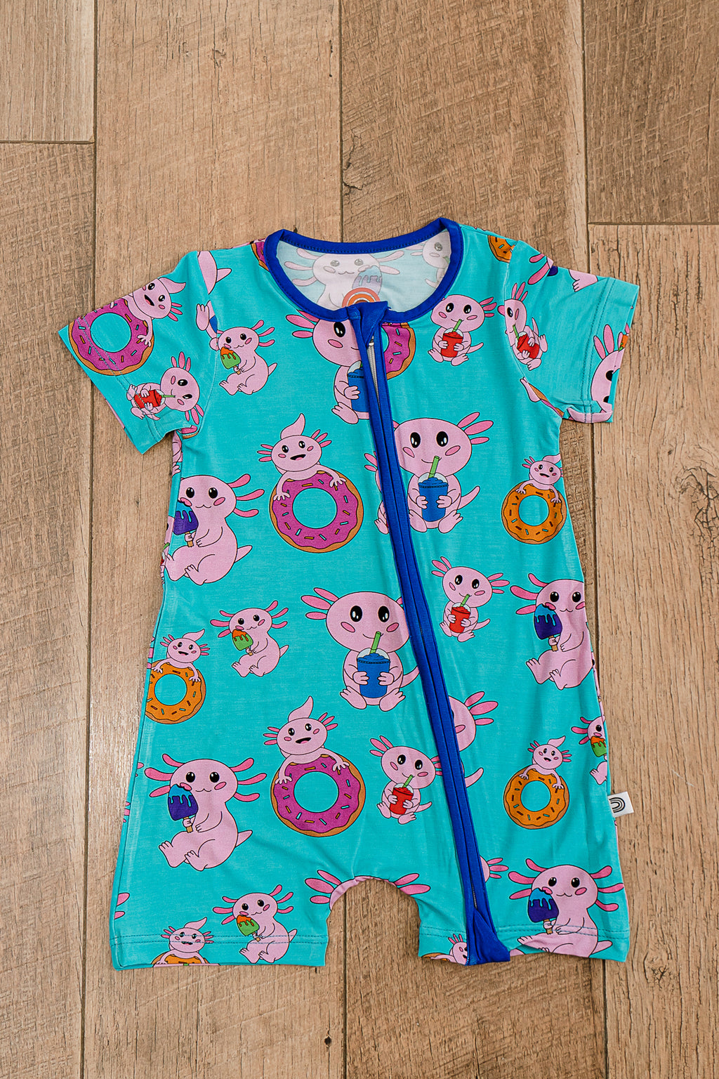 Axolotlicious bamboo short sleeve zippy laid flat, showcasing colorful axolotl design with short sleeves and two-way zipper