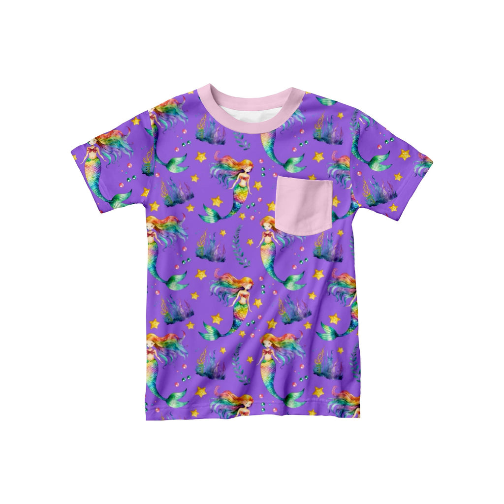 Kids bamboo t-shirt in purple with vibrant rainbow mermaids and a pink coordinating front pocket, displayed flat against a white background.