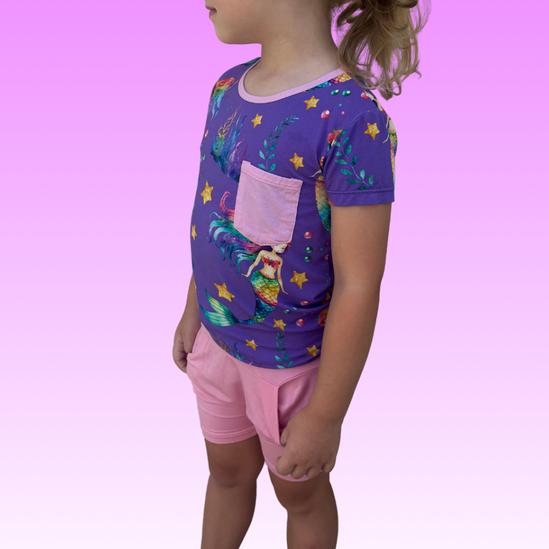 Child wearing a Rainbow Reef Bamboo shirt with a playful, tropical feel