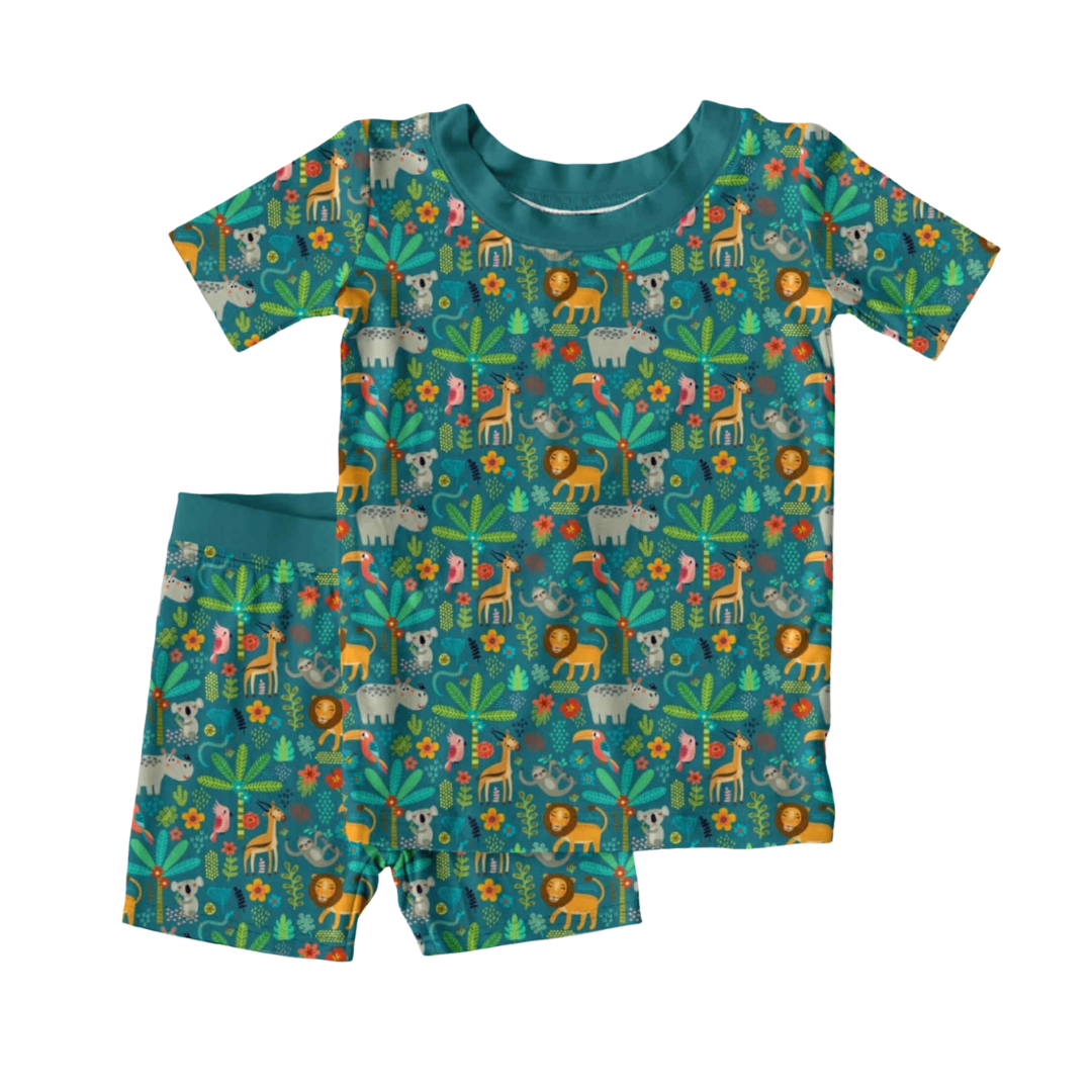 Bamboo 2-piece children’s pajama set with short sleeves and shorts, featuring a playful safari animal print on a teal background, displayed on a white surface.