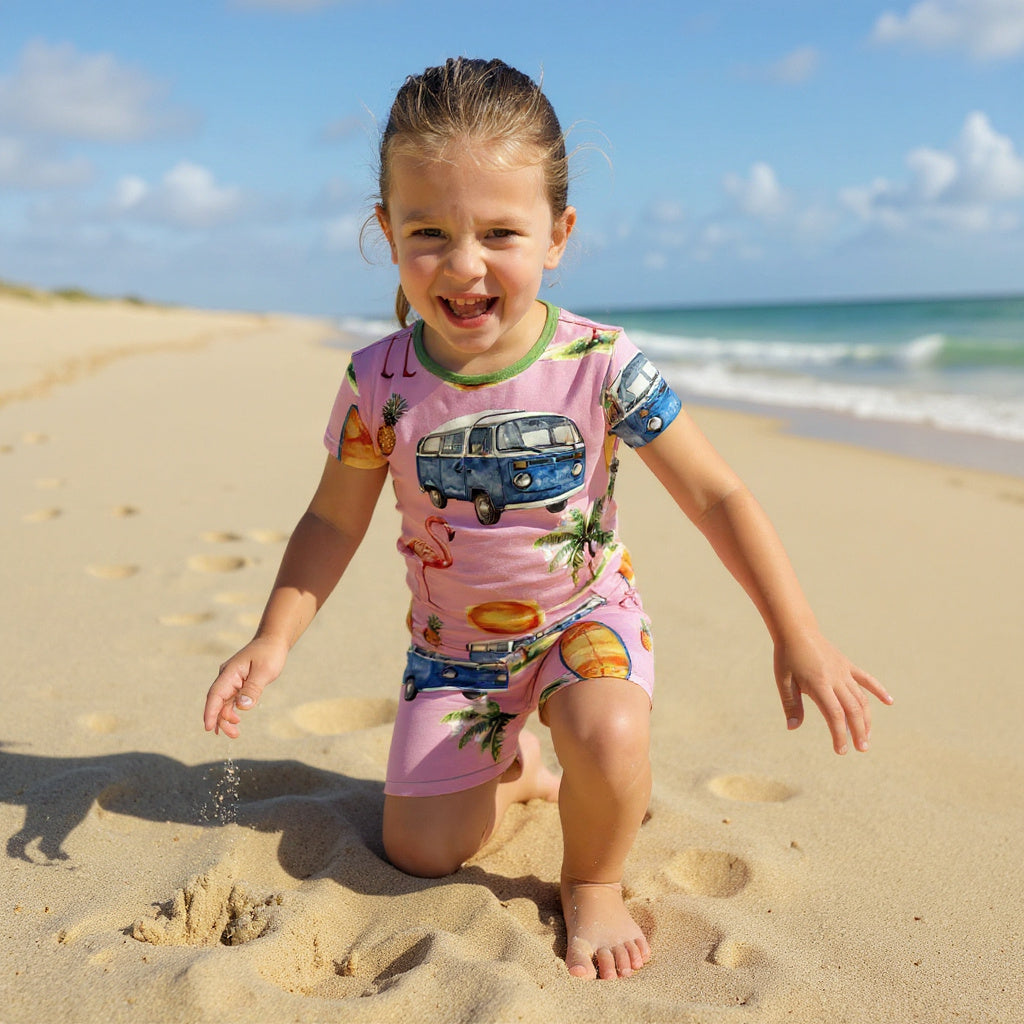 Girl wearing beach themed bamboo sleepwear while playing in the sand. 